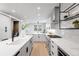 Modern kitchen featuring a large island with bar seating, stainless steel appliances, and stylish pendant lighting at 2520 S Cherokee St, Denver, CO 80223