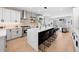 Open-concept kitchen featuring a large island, modern lighting, and stainless appliances at 2520 S Cherokee St, Denver, CO 80223