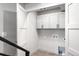 Efficient laundry room featuring ample storage cabinets and modern fixtures at 2520 S Cherokee St, Denver, CO 80223