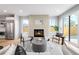 Sun-filled living room features a tiled fireplace and open layout perfect for modern living at 2520 S Cherokee St, Denver, CO 80223