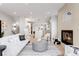 Spacious living area with fireplace and lots of natural light, seamlessly connecting to the kitchen and dining areas at 2520 S Cherokee St, Denver, CO 80223
