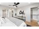 Bright main bedroom with contemporary ceiling fan, stylish decor, and hardwood floors at 2520 S Cherokee St, Denver, CO 80223