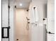 Modern shower with glass doors, featuring sleek fixtures and neutral tile at 2520 S Cherokee St, Denver, CO 80223