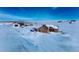 Aerial view of a house, barn, and expansive snowy land at 7295 Sunset Ave, Elizabeth, CO 80107