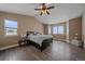 Spacious bedroom with wood floors, large windows, and a ceiling fan at 7295 Sunset Ave, Elizabeth, CO 80107