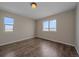 Spacious bedroom with two windows and wood-look flooring at 7295 Sunset Ave, Elizabeth, CO 80107