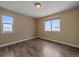 Simple bedroom with hardwood floors and two large windows at 7295 Sunset Ave, Elizabeth, CO 80107