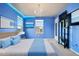 Blue bedroom with a king-size bed and modern decor at 6100 E 133Rd Ave, Thornton, CO 80602