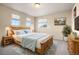 Light and airy bedroom with a wooden bed frame at 6100 E 133Rd Ave, Thornton, CO 80602