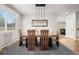 Dining room with a modern light fixture and wooden table at 6100 E 133Rd Ave, Thornton, CO 80602