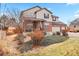 Two-story home with landscaping, a front porch, and a two-car garage at 6100 E 133Rd Ave, Thornton, CO 80602