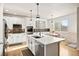 Modern kitchen with white cabinets, stainless steel appliances, and an island at 6100 E 133Rd Ave, Thornton, CO 80602