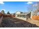 Back view of home and backyard with a screened-in porch and wood fence at 3606 S Olathe Way, Aurora, CO 80013