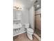 Bathroom featuring a vanity, toilet, and tiled shower at 3606 S Olathe Way, Aurora, CO 80013