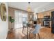 Bright dining area with modern furniture, hardwood floors, and sliding door to the backyard at 3606 S Olathe Way, Aurora, CO 80013