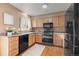 Well-equipped kitchen with modern appliances, ample cabinet space, and hardwood floors at 3606 S Olathe Way, Aurora, CO 80013