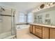 Bright bathroom featuring a separate shower and bathtub with a tiled surround and double vanity at 17611 E 104Th Pl, Commerce City, CO 80022