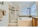 Bathroom featuring a separate shower and bathtub with a tiled surround and single vanity at 17611 E 104Th Pl, Commerce City, CO 80022