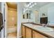 Bright bathroom with a double vanity and a shower-tub combination, offering both convenience and comfort at 17611 E 104Th Pl, Commerce City, CO 80022