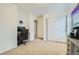 Bright room featuring a closet with a sliding door, neutral carpet and walls, and office space at 17611 E 104Th Pl, Commerce City, CO 80022