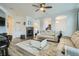 Comfortable living room featuring hardwood floors, a fireplace, and a view of the kitchen at 17611 E 104Th Pl, Commerce City, CO 80022