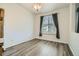 Bright room with hardwood floors, a window with curtains, and neutral paint at 17611 E 104Th Pl, Commerce City, CO 80022