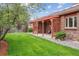 Beautiful backyard with mature tree, manicured lawn, and pergola-covered patio area at 11254 E Colorado Dr, Aurora, CO 80012