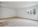 Spacious bedroom featuring neutral carpet, large windows, and ample natural light at 11254 E Colorado Dr, Aurora, CO 80012