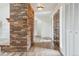 Inviting entryway featuring a brick accent wall, wood floors, and white closet doors at 11254 E Colorado Dr, Aurora, CO 80012