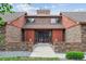 Charming two story brick home with mature trees, a walkway and a beautiful entry at 11254 E Colorado Dr, Aurora, CO 80012