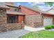Inviting home with brick accents, complemented by manicured greenery and a spacious two car garage at 11254 E Colorado Dr, Aurora, CO 80012