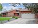 Beautiful brick home showcasing mature trees and a two-car garage in a serene neighborhood at 11254 E Colorado Dr, Aurora, CO 80012