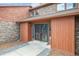Close up view of brick and wood home with beautiful front door and manicured landscape at 11254 E Colorado Dr, Aurora, CO 80012