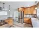 Modern kitchen with stainless steel appliances, tile backsplash, and wood cabinetry at 11254 E Colorado Dr, Aurora, CO 80012