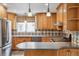 Well-equipped kitchen with stainless steel appliances and wooden cabinets at 11254 E Colorado Dr, Aurora, CO 80012