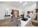 Bright living room featuring hardwood floors, vaulted ceilings, a fireplace, and stylish decor at 11254 E Colorado Dr, Aurora, CO 80012