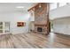 Bright living room with vaulted ceilings, wood floors and a brick fireplace at 11254 E Colorado Dr, Aurora, CO 80012