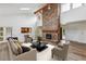 Spacious living room with vaulted ceilings, brick fireplace, and ample natural light at 11254 E Colorado Dr, Aurora, CO 80012