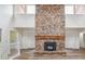 Large living room featuring a brick fireplace, vaulted ceilings, and lots of natural light at 11254 E Colorado Dr, Aurora, CO 80012