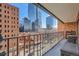 Balcony view with iron railing and views of tall buildings in an urban neighborhood at 1551 Larimer St # 704, Denver, CO 80202