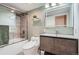 Bathroom featuring a modern vanity, sleek fixtures, and a combined shower-bathtub with a glass door at 1551 Larimer St # 704, Denver, CO 80202