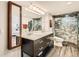 Modern bathroom with dual sinks, large mirror, and a glass-enclosed shower with stylish tile work at 1551 Larimer St # 704, Denver, CO 80202