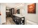 Bathroom featuring dual sinks, a large mirror, wood-look flooring, and closet with ample storage space at 1551 Larimer St # 704, Denver, CO 80202