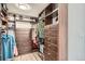 Walk-in closet with custom wood shelving, drawers, and hanging space, providing ample storage solutions at 1551 Larimer St # 704, Denver, CO 80202