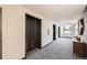 Hallway area with elevator access, modern decor, carpeted floor, and cityscape view from the window at 1551 Larimer St # 704, Denver, CO 80202