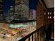 Balcony view overlooking a busy retail area, and office buildings at night at 1551 Larimer St # 704, Denver, CO 80202