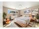 Bright bedroom with two windows, modern decor, light wood flooring and a cozy rug at 12843 W Jewell Cir, Lakewood, CO 80228