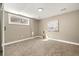 Bedroom with a large window, artwork, and tan carpet at 12843 W Jewell Cir, Lakewood, CO 80228