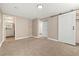 Bedroom with closet and barn door, carpeted floors and neutral walls at 12843 W Jewell Cir, Lakewood, CO 80228