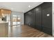 Bright dining room features hardwood floors, modern accent wall, and sliding glass doors at 12843 W Jewell Cir, Lakewood, CO 80228